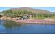 Scenic pond with cascading waterfall, colorful flowers, and picturesque golf course views at 41216 N Shadow Creek Ct, Anthem, AZ 85086
