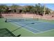 Exterior shot of a pristine tennis court with scenic landscaping, inviting residents for a game at 41216 N Shadow Creek Ct, Anthem, AZ 85086