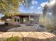Landscaped backyard with a covered patio and stone pathway at 42950 W Misty Morning Ln, Maricopa, AZ 85138