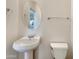 Powder room with pedestal sink and toilet at 42950 W Misty Morning Ln, Maricopa, AZ 85138