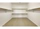 Large walk-in closet with custom shelving at 42950 W Misty Morning Ln, Maricopa, AZ 85138