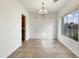 Spacious dining room with large windows and tile floors at 42950 W Misty Morning Ln, Maricopa, AZ 85138