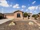 Single-story home with desert landscaping and a two-car garage at 42950 W Misty Morning Ln, Maricopa, AZ 85138