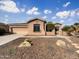 Single-story home with desert landscaping and a two-car garage at 42950 W Misty Morning Ln, Maricopa, AZ 85138