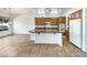 Kitchen with island, wood cabinets, and modern appliances at 42950 W Misty Morning Ln, Maricopa, AZ 85138