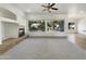 Spacious living room with large windows and neutral color palette at 42950 W Misty Morning Ln, Maricopa, AZ 85138