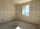 Spacious room featuring an unfinished wall and a large window offering ample natural light at 4509 S 95Th Dr, Tolleson, AZ 85353