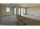 Open-concept living room with unfinished walls, large windows, and sliding glass doors to outdoors at 4509 S 95Th Dr, Tolleson, AZ 85353
