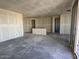 Large, open living space featuring sliding glass doors and unfinished walls, ready for customization at 4509 S 95Th Dr, Tolleson, AZ 85353