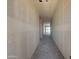 Hallway boasts drywall walls and a clear view of the backyard through large glass windows at 4517 S 95Th Dr, Tolleson, AZ 85353