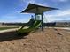 Modern playground equipment under a shaded area at 4517 S 95Th Dr, Tolleson, AZ 85353