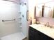 Main bathroom with shower stall, grab bars, and double vanity at 7419 E Abilene Ave, Mesa, AZ 85208