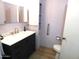 Bathroom with dark vanity, marble countertop, and walk-in shower at 7419 E Abilene Ave, Mesa, AZ 85208