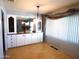 Bright dining area with built-in hutch and large window at 7419 E Abilene Ave, Mesa, AZ 85208