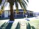 Ranch style home with carport and mature palm tree landscaping at 7419 E Abilene Ave, Mesa, AZ 85208
