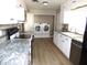 Updated kitchen with white cabinets, granite countertops and laundry area at 7419 E Abilene Ave, Mesa, AZ 85208
