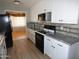 Modern kitchen with white cabinets, granite counters, and stainless steel appliances at 7419 E Abilene Ave, Mesa, AZ 85208