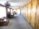 Sunroom with wood paneled walls, carpet, and access to patio at 7419 E Abilene Ave, Mesa, AZ 85208