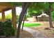 Lush backyard featuring a stone pathway, mature trees, and green lawn at 7712 S 25Th Ave, Phoenix, AZ 85041
