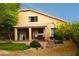Spacious backyard with covered patio, lush greenery, and a basketball court at 7712 S 25Th Ave, Phoenix, AZ 85041