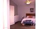 This cozy bedroom features an artful accent, white closet doors, and hardwood floors at 7712 S 25Th Ave, Phoenix, AZ 85041