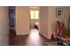 View of the hallway featuring hardwood floors, leading to a bathroom, bedroom, decor, and modern art at 7712 S 25Th Ave, Phoenix, AZ 85041