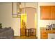 Open-concept living room with modern furniture, a dog playpen, and archways at 7712 S 25Th Ave, Phoenix, AZ 85041