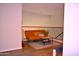 Cozy loft area features an orange futon, colorful pillows, rug, coffee table, and a wrought iron railing at 7712 S 25Th Ave, Phoenix, AZ 85041