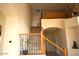 Staircase with wood and wrought iron railing, wood flooring, and lots of light at 7712 S 25Th Ave, Phoenix, AZ 85041