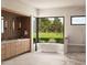 Spa-like bathroom with soaking tub, walk-in shower, and modern vanity at 8226 E Davenport Dr, Scottsdale, AZ 85260