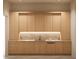 Elegant wet bar with light wood cabinets and marble backsplash at 8226 E Davenport Dr, Scottsdale, AZ 85260