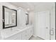 Bright bathroom with double vanity, white cabinetry, and a glass-enclosed shower at 9523 E Sandy Vista Dr, Scottsdale, AZ 85262