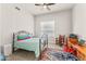 Cozy bedroom with a ceiling fan, tiled floor, and a large window, complemented by vintage-style furnishings at 9523 E Sandy Vista Dr, Scottsdale, AZ 85262