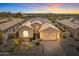 Stunning exterior elevation featuring desert landscaping and mountain views at sunset at 9523 E Sandy Vista Dr, Scottsdale, AZ 85262