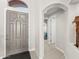 Inviting foyer featuring a stylish front door and arched entryway, complemented by neutral tones and tile flooring at 9523 E Sandy Vista Dr, Scottsdale, AZ 85262