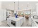 Open concept kitchen featuring white cabinets, an island, and seamless flow into living and dining areas at 9523 E Sandy Vista Dr, Scottsdale, AZ 85262