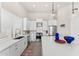 Modern kitchen featuring white cabinets, stainless steel appliances, and a large island with decor at 9523 E Sandy Vista Dr, Scottsdale, AZ 85262