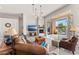 Inviting living room featuring a fireplace, TV, comfortable seating, and natural light at 9523 E Sandy Vista Dr, Scottsdale, AZ 85262