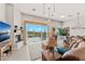 Open-concept living area with a fireplace, comfortable seating, and views of the pool and desert landscape at 9523 E Sandy Vista Dr, Scottsdale, AZ 85262