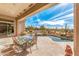 Covered patio with outdoor dining area overlooking a pool and desert landscape at 9523 E Sandy Vista Dr, Scottsdale, AZ 85262