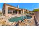 Charming kidney-shaped pool with rock details and desert landscaping, perfect for relaxation at 9523 E Sandy Vista Dr, Scottsdale, AZ 85262