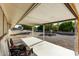 Covered patio overlooking a gravel backyard with fruit trees at 9719 W Newport Dr, Sun City, AZ 85351