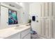 Clean bathroom with a single sink vanity, toilet, and shower at 9719 W Newport Dr, Sun City, AZ 85351