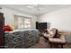 Bedroom with large closet and plush seating area at 9719 W Newport Dr, Sun City, AZ 85351