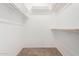 Large walk-in closet with double hanging rods and shelving at 9719 W Newport Dr, Sun City, AZ 85351