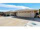Ranch home with a two-car garage and a landscaped yard at 9719 W Newport Dr, Sun City, AZ 85351