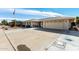 Front view of a ranch home with a two-car garage at 9719 W Newport Dr, Sun City, AZ 85351