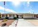White brick ranch home with landscaped yard, two-car garage, and flagpole at 9719 W Newport Dr, Sun City, AZ 85351