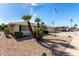 Landscaped front yard with palm trees and gravel at 9719 W Newport Dr, Sun City, AZ 85351