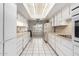 Long kitchen with ample counter space and white cabinets at 9719 W Newport Dr, Sun City, AZ 85351